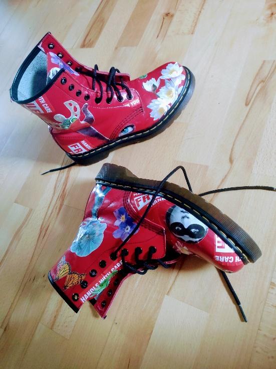 Red shoes decorated with analog collage elements.